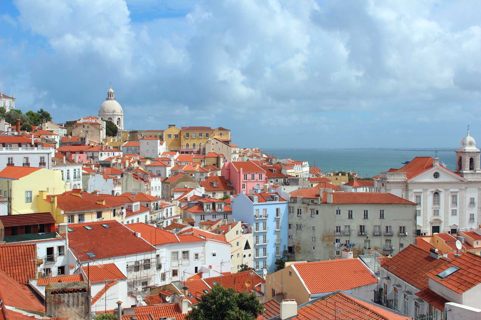 Panoramic view from Miradouro das Portas do Sol of the Alfama district of Seville with its red rooftops.